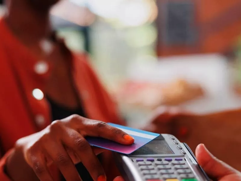 Woman using contactless payment on card reader