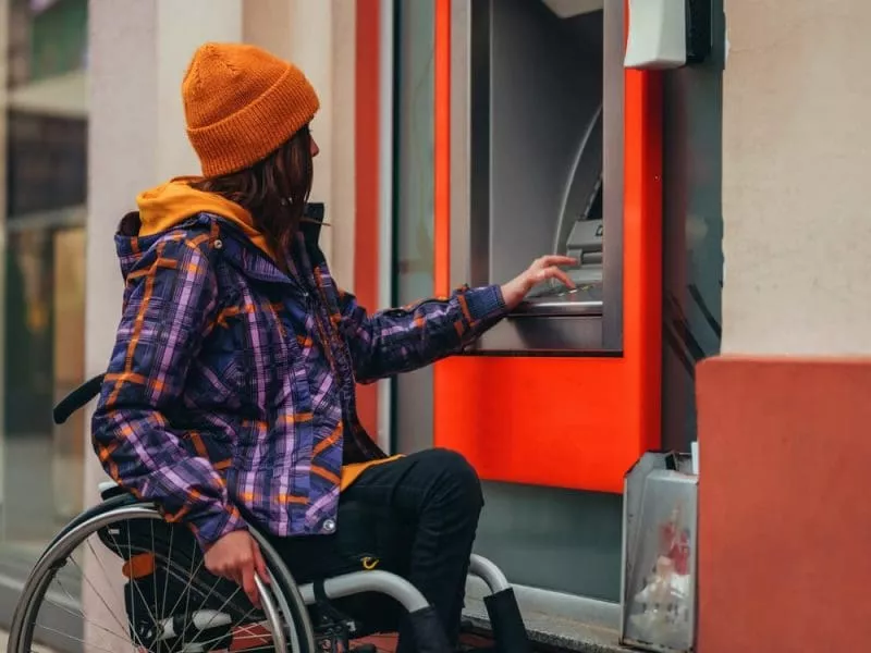 Woman in wheelchair at ATM