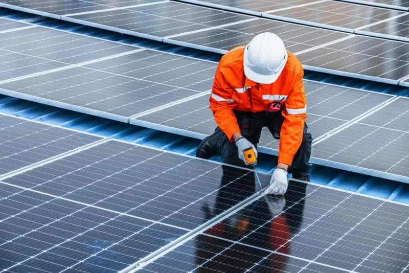 Man installing solar panel