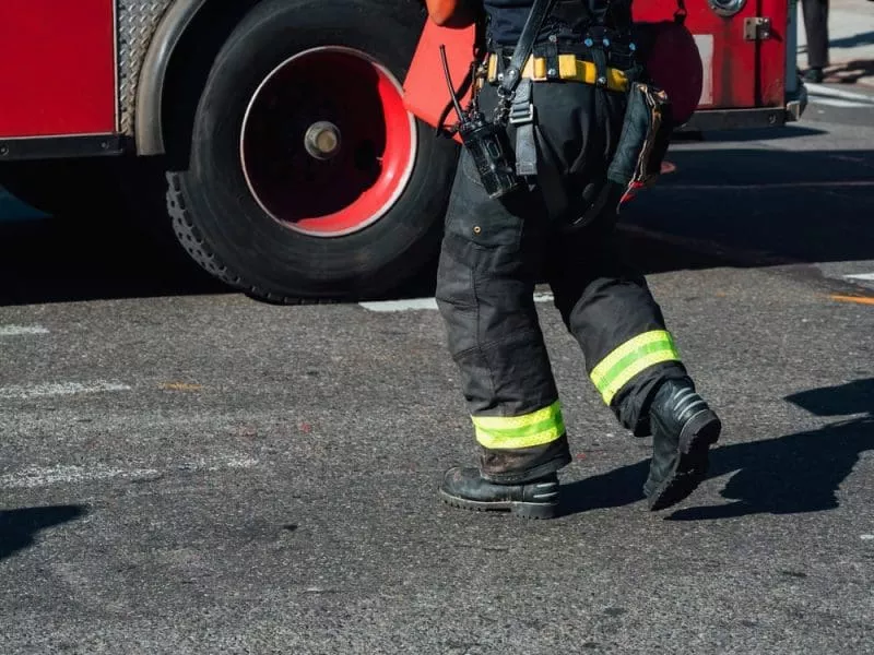 Firefighter walking towards fire engine