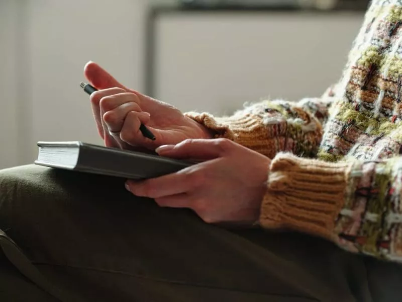 Woman wearing pen and a book