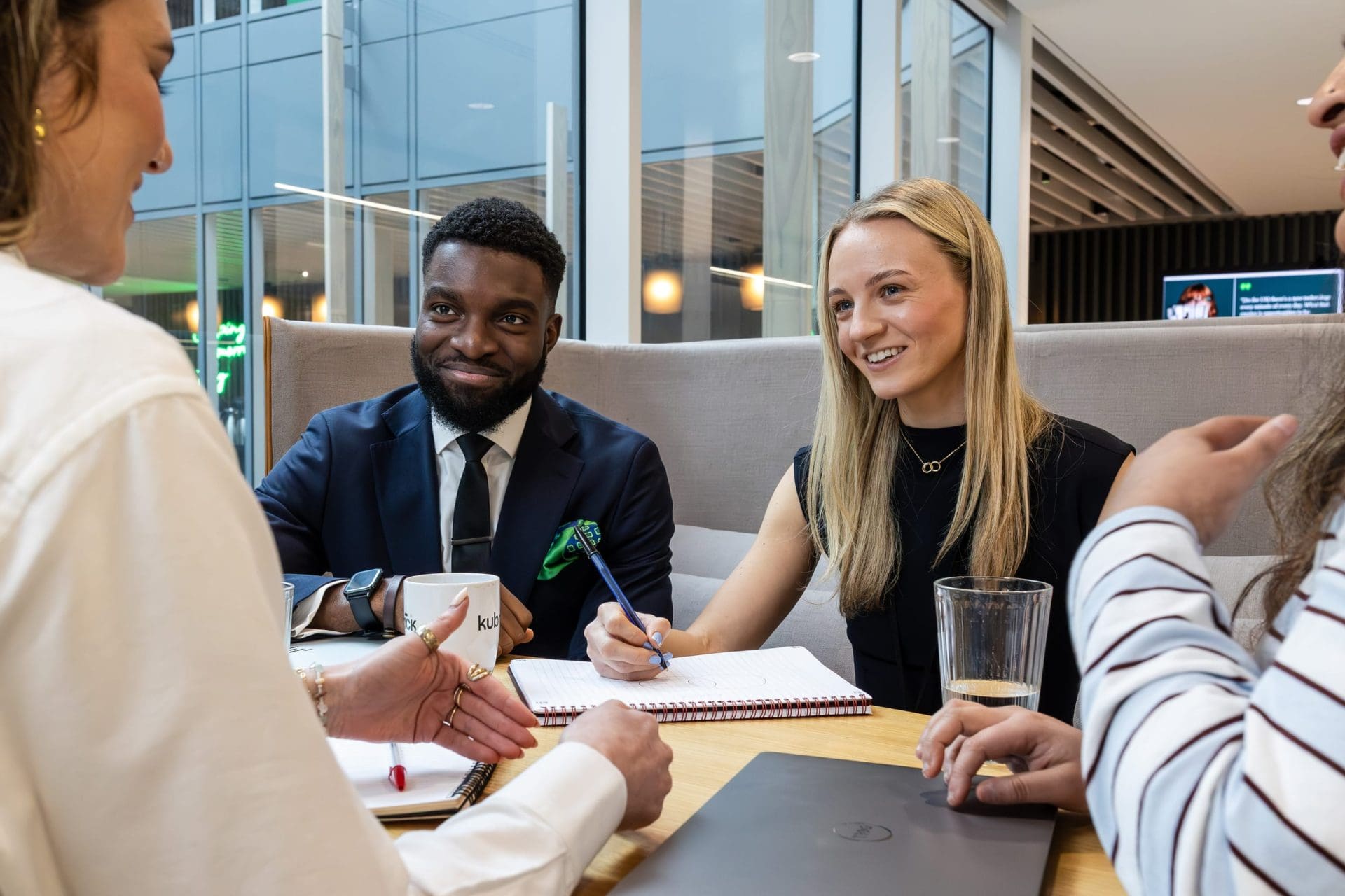 Woman writing notes and listening to ideas