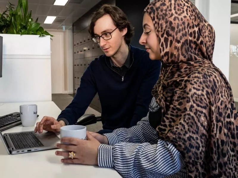 Man and woman working on laptop