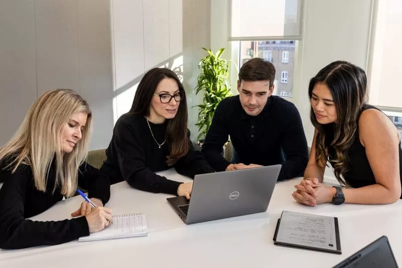 Group working on laptop together