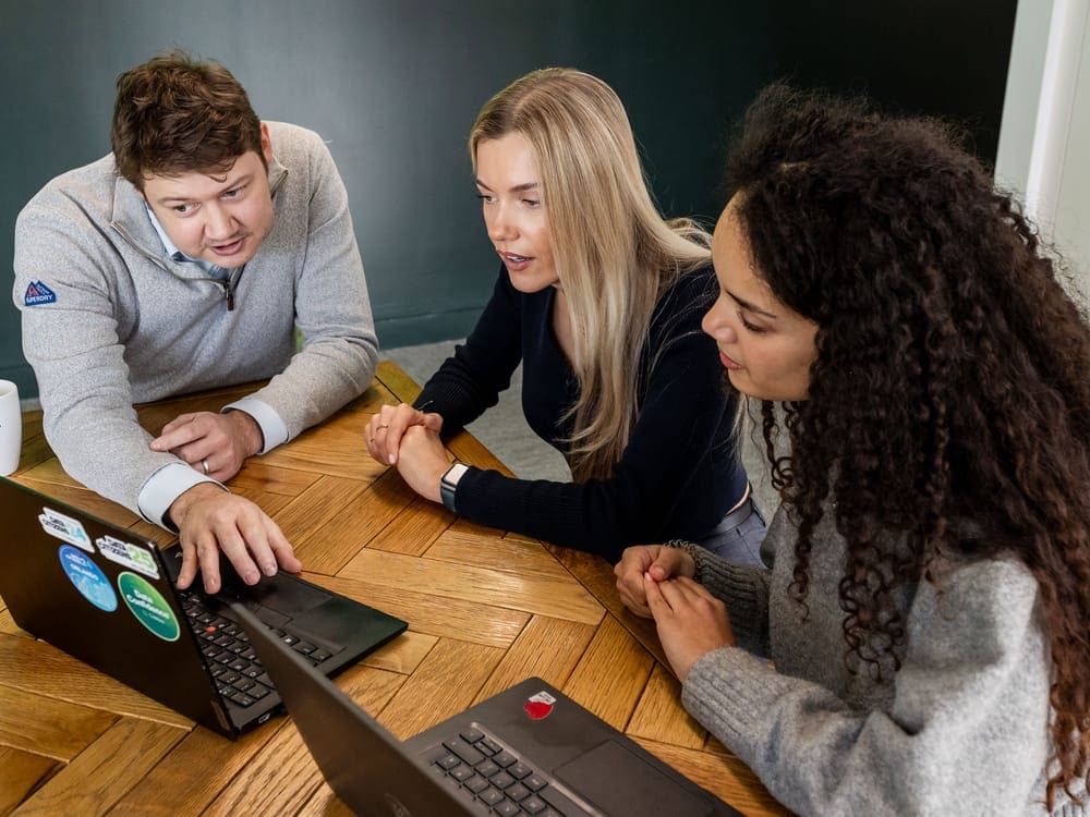 Colleagues looking through work on laptop together